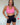 Woman in pink bather top and black shorts 