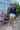 Woman wearing long sleeve navy AMOUR rashguard with hat, jewelery and shorts