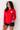 Woman in red rashguard with white heart featuring the word AMOUR - and navy bather shorts